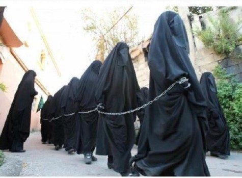 Christian women chained, forced to wear veils, and sold as sex slaves by members of ISIS