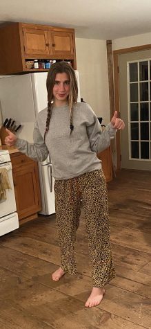 A recently graduated Senior, Evie is comfortable in her leopard print pajamas, a subject that she has just written an article about! 